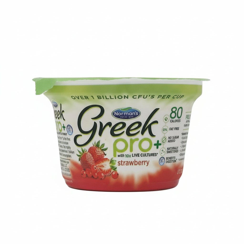 A container of Norman's Greek Pro+ Strawberry yogurt, with the lid on and a visible label showing the brand, product name, and images of strawberries. The container is labeled as having over 1 billion CFU's per cup, which is a measure of probiotics.