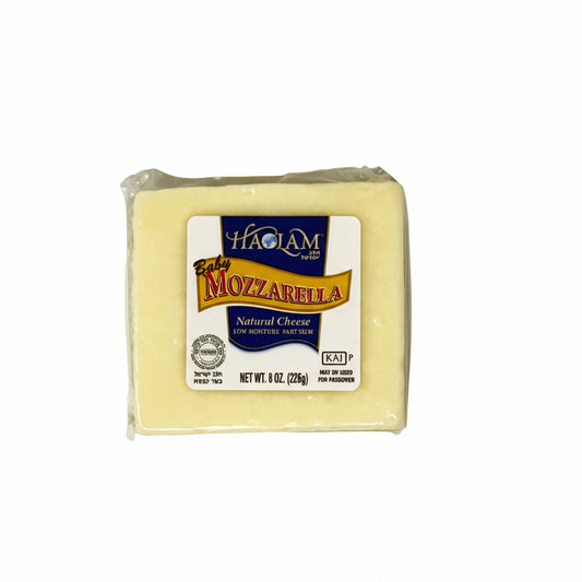 Block of mozzarella cheese with a label on a white background